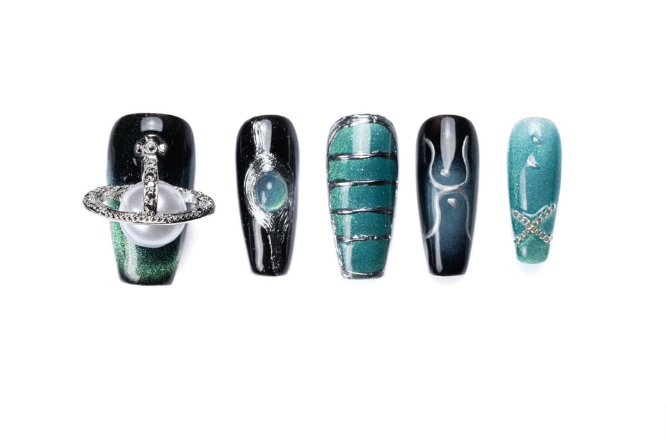 gothic coffin nails displaying black and teal gradient, silver orb embellishment, pearl accent, and metallic chain details