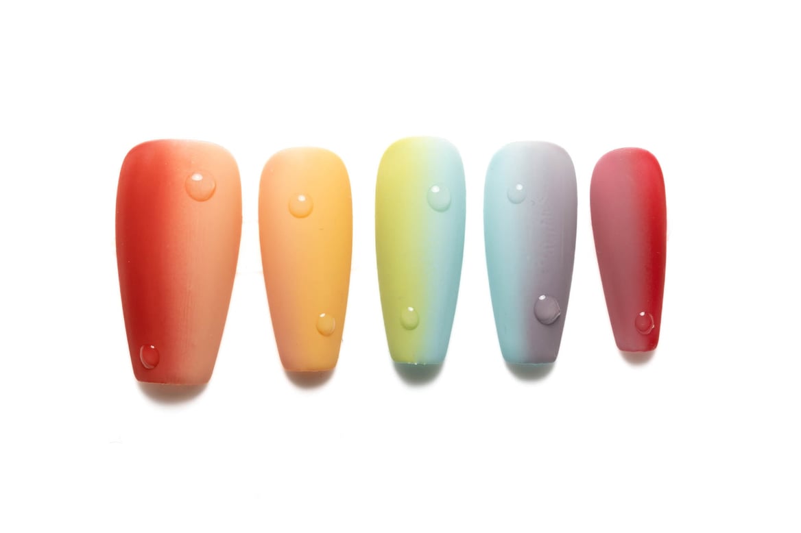 Medium-length coffin press-on nails featuring vibrant rainbow ombre design transitioning through red, orange, yellow, green, blue, and purple