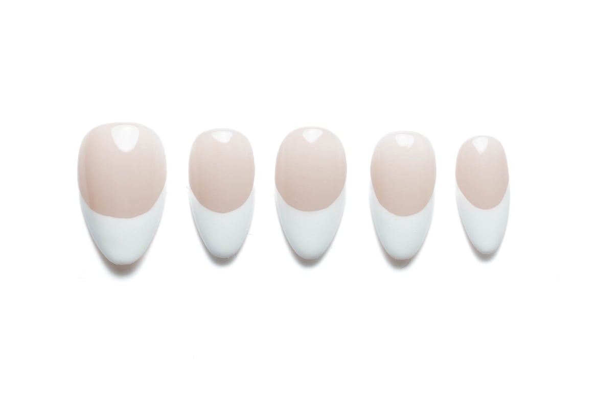 Almond-shaped press-on nails with soft pink base and classic French tip design, perfect for elegant everyday wear