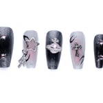 Edgy coffin-shaped press-on nails with black and sheer finishes, decorated with celestial charms like stars, orbs, and crosses.