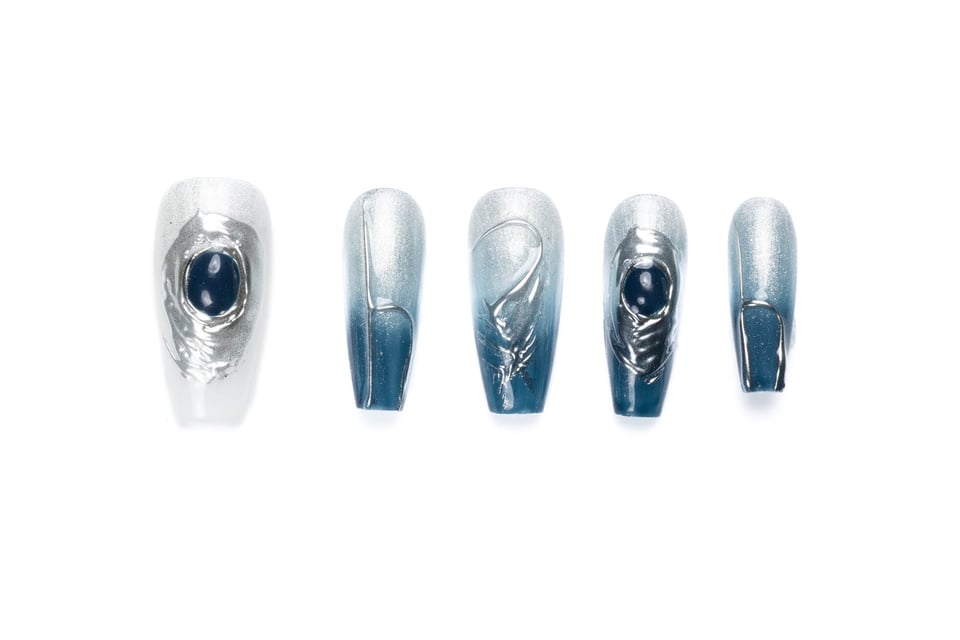 Medium-length coffin press-on nails with blue ombre design, silver accents, and textured finish featuring dark blue jewel embellishments