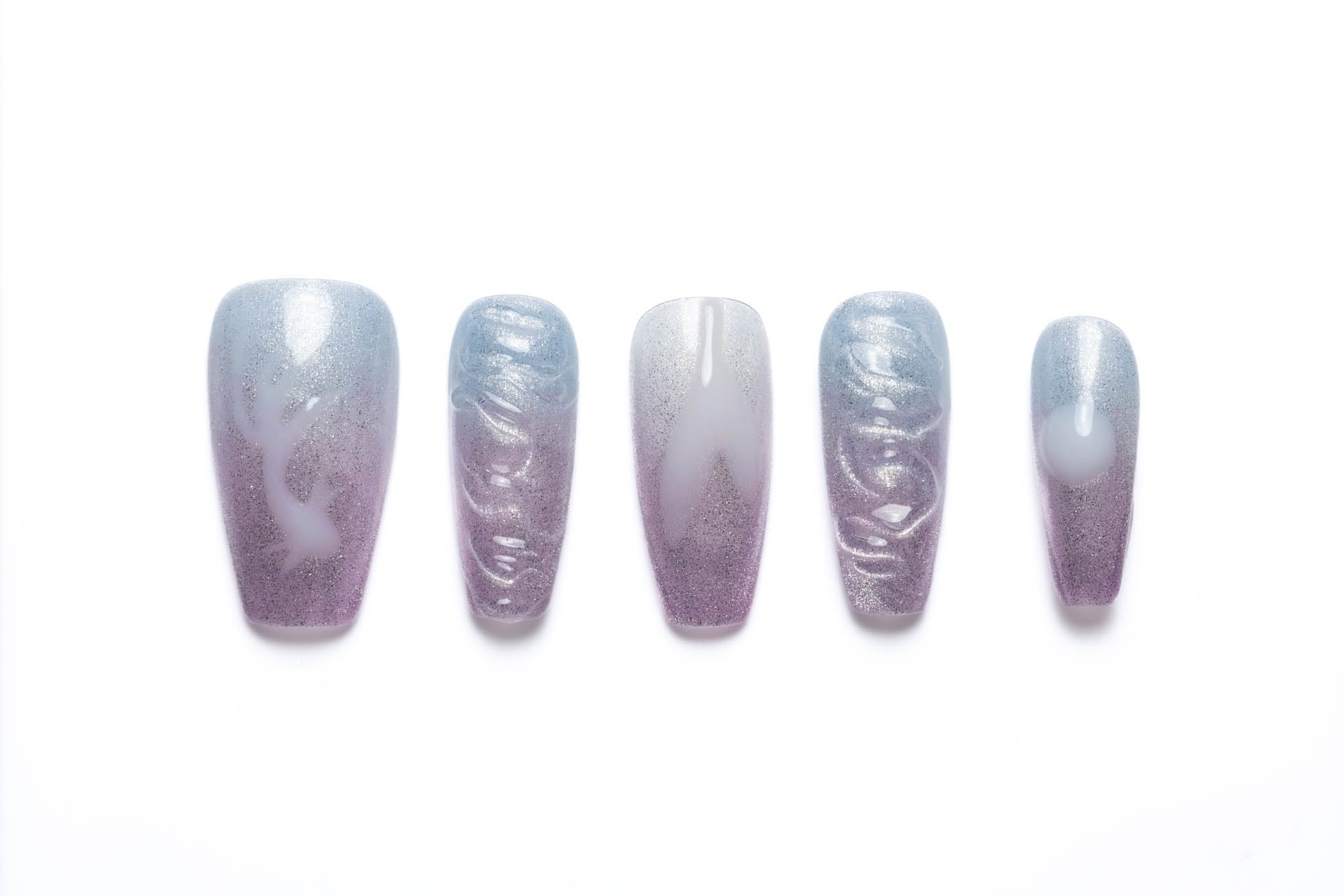 Medium coffin press-on nails with ocean-inspired blue and purple ombre design, featuring wave texture and seashell accents