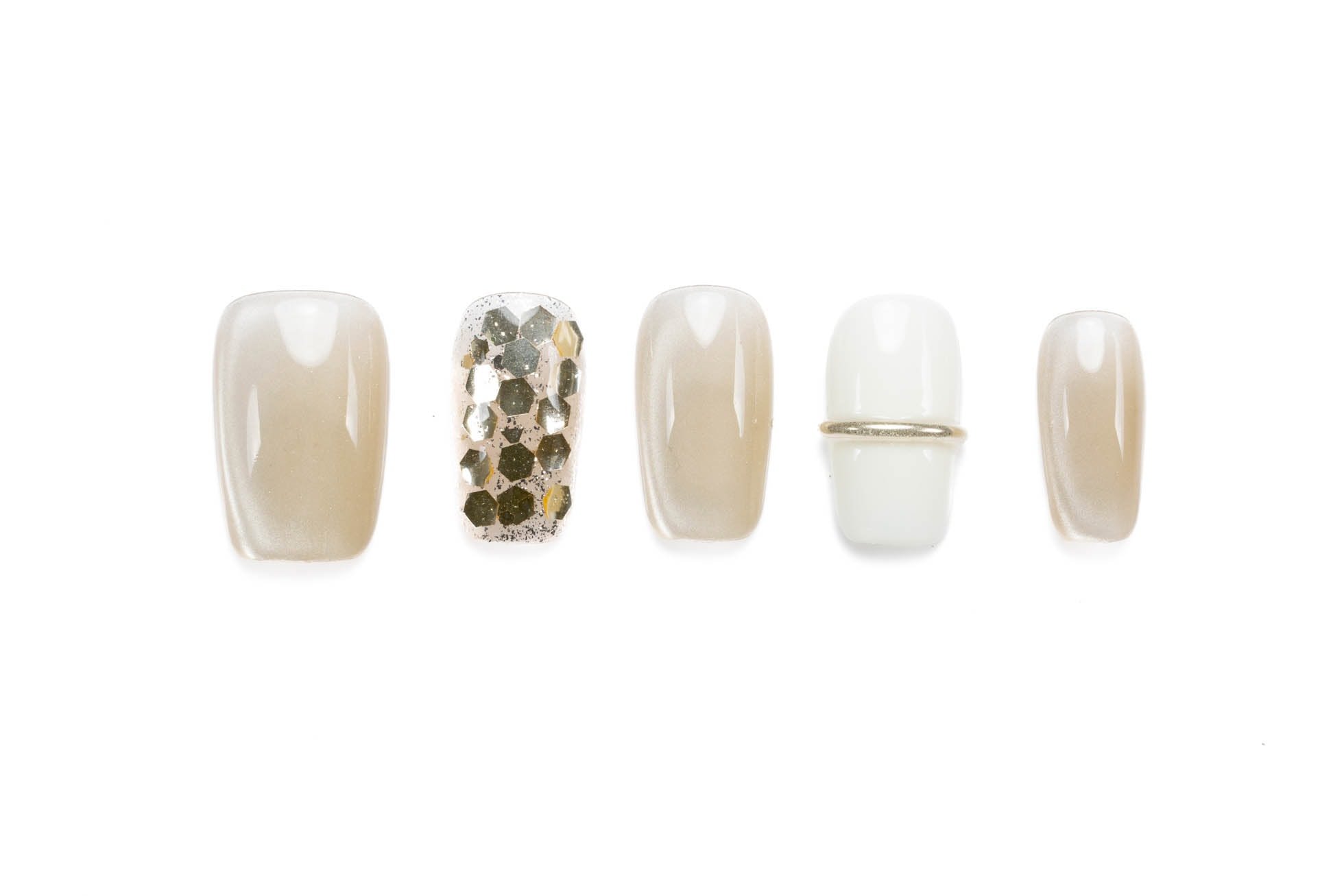 Short squoval press-on nails in nude with gold glitter and metallic band accent, perfect for everyday elegance