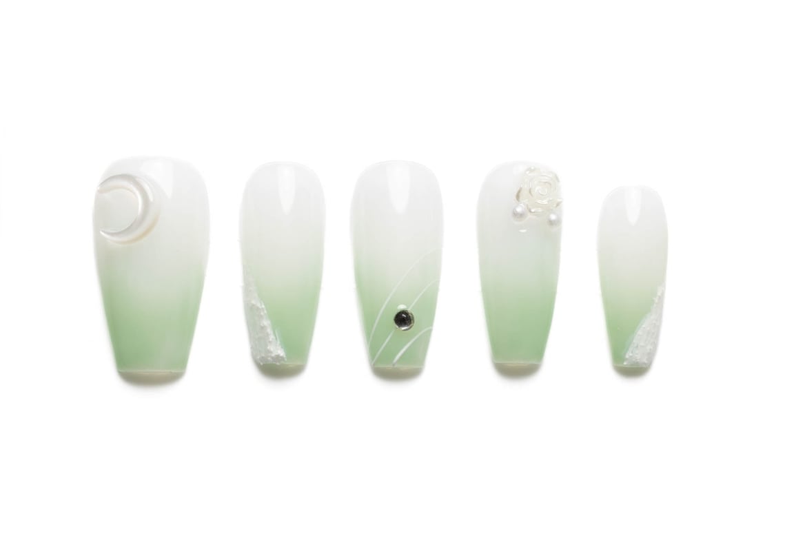 Pastel green ombre coffin press-on nails with romantic heart and moon designs, featuring lace accents