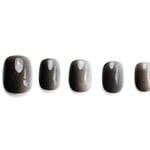 Short squoval press-on nails with dark shimmering cat-eye effect, showing subtle glamour and dimension