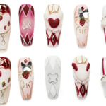 Medium-length coffin press-on nails with a Queen of Hearts theme, including strawberries, crowns, playing card suits, pearls, and glitter accents.