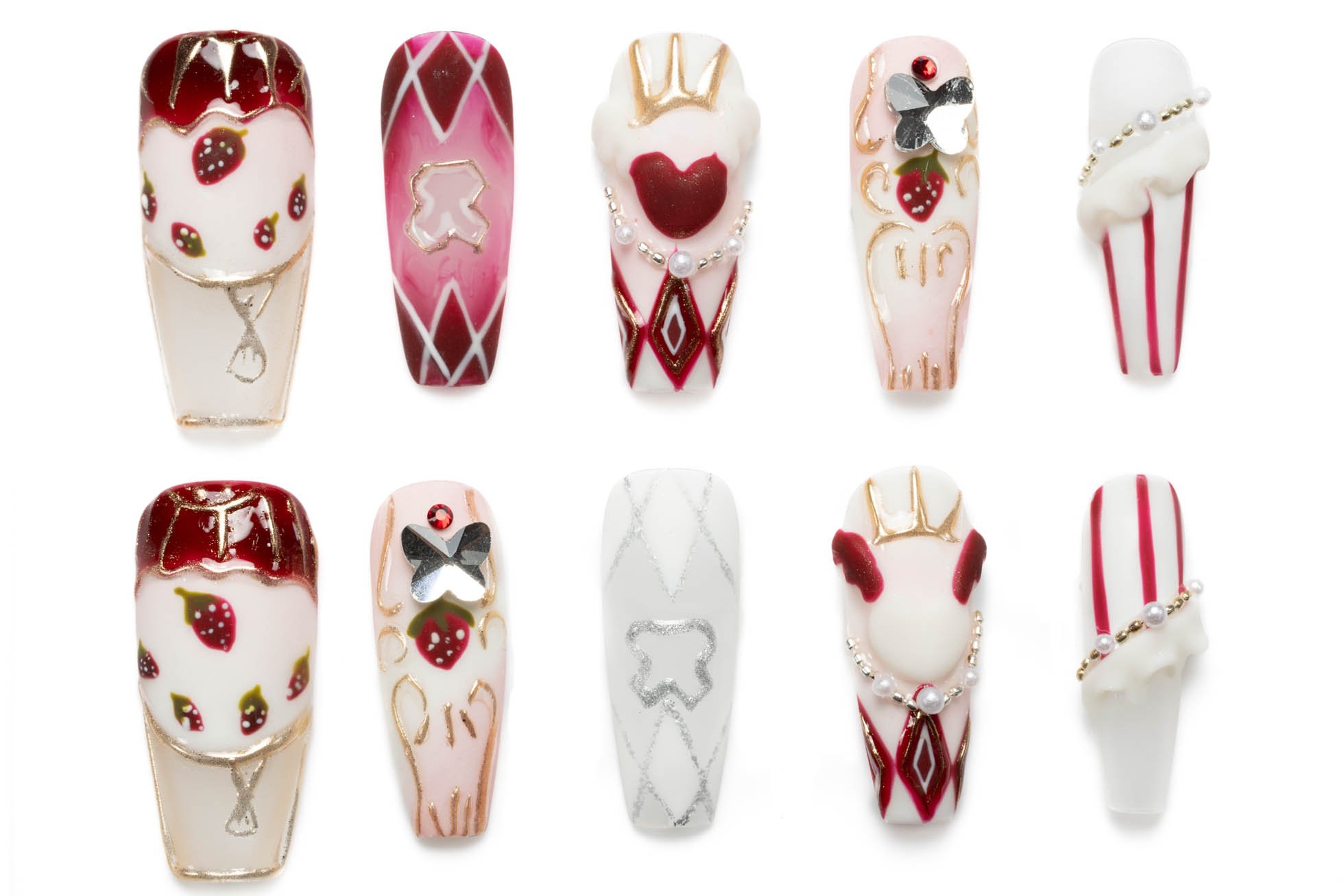 Medium-length coffin press-on nails with a Queen of Hearts theme, including strawberries, crowns, playing card suits, pearls, and glitter accents.