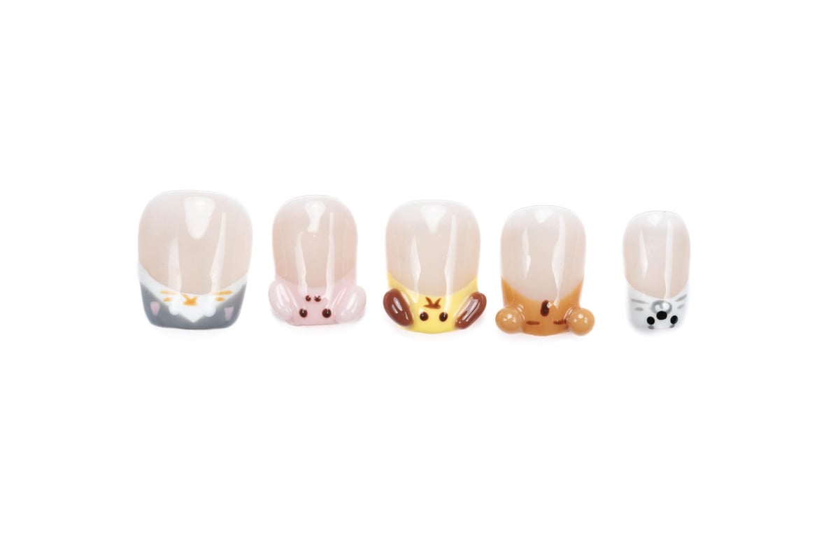 Short squoval press-on nails with cute animal designs on natural base, featuring kitten, puppy, bunny and chick patterns