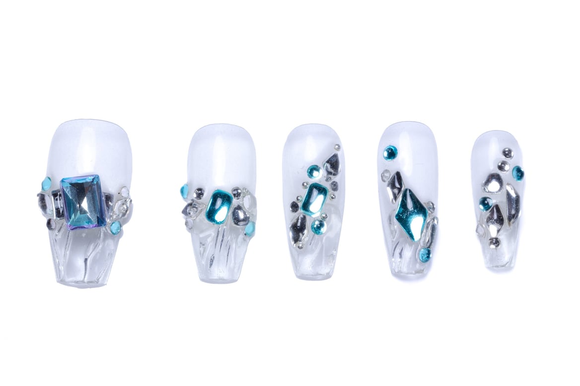 Clear press-on nails with textured surface, icy blue and silver embellishments - Glacial Glamour collection