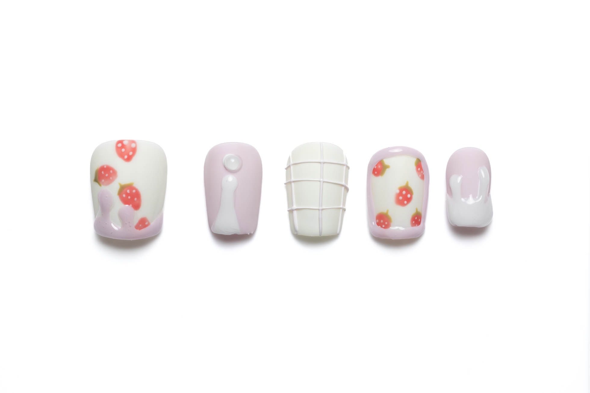 Short squoval press-on nails featuring cute strawberry patterns, pink and white designs, and delicate summer accents