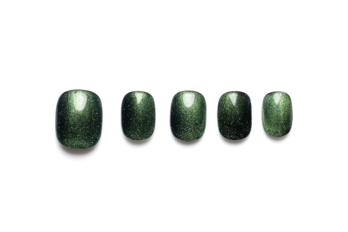 Short squoval press-on nails featuring a dark green cat-eye finish with subtle shimmer effect