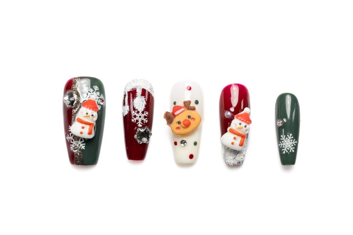 Holiday-themed coffin press-on nails with 3D snowmen, reindeer, and snowflakes in festive red, green, and white colors