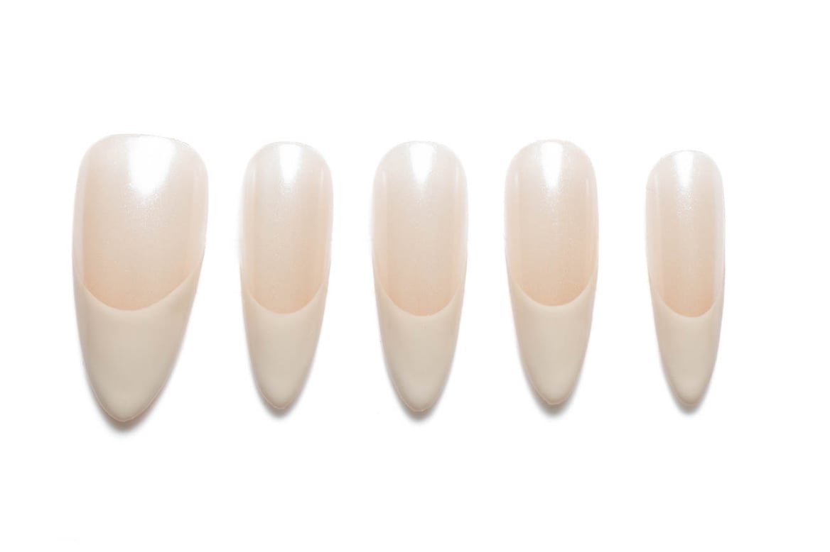 Classic almond-shaped press-on nails in a soft neutral porcelain shade with a subtle shimmer